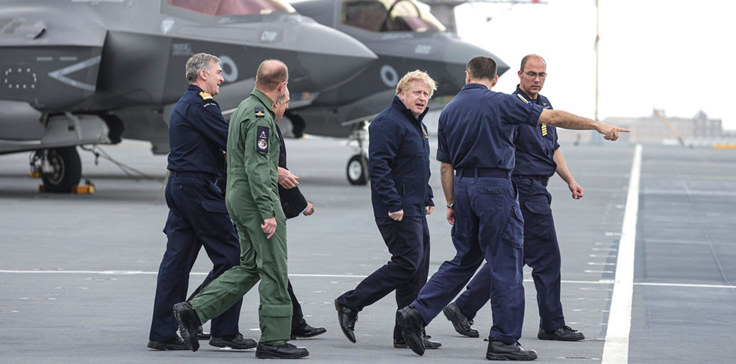 Prime Minister Boris Johnson with officers on board the QE