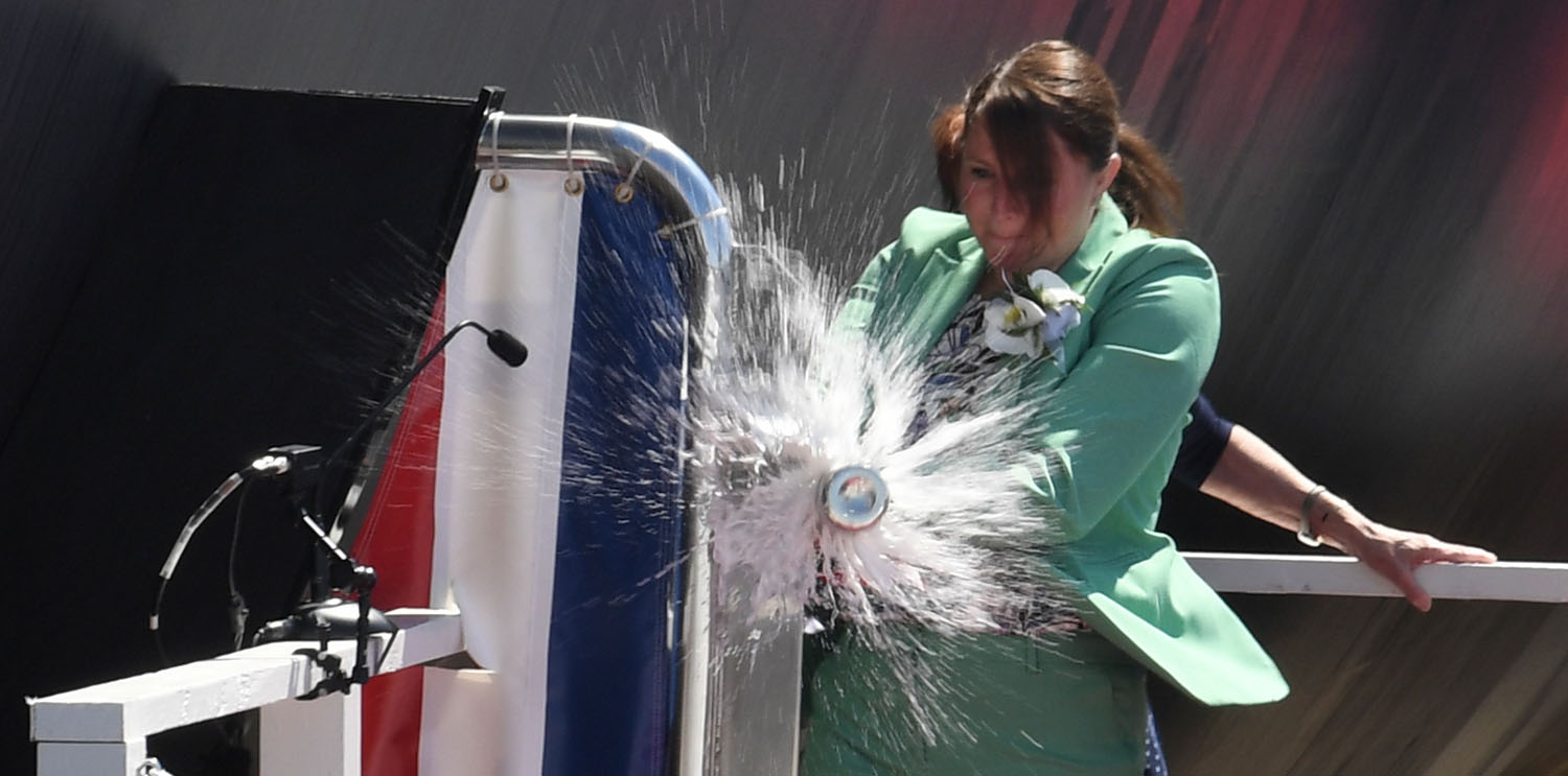 Sarah Greenert McNichol smashing the champagne bottle