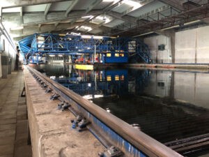 Der 300 Meter lange Schleppkanal der HSVA mit Schleppgestell, Schleppwagen und dem Modell der F126. Foto: BAAINBw/Patrick Janta